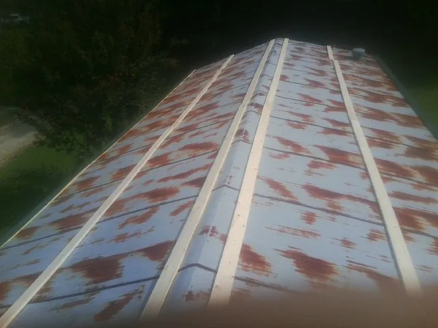 Rusted metal roof panels with new wood purlins before replacement — Storm Damage Roof Repair in Lehighton by Roofing Brothers