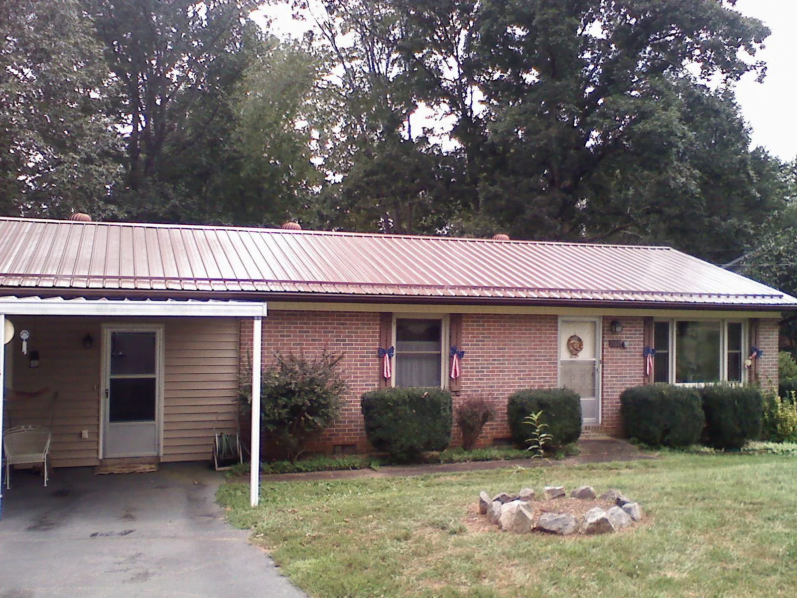 Bronze metal roof and carport on a brick ranch home — Roof Repair work by our crew in Lehighton