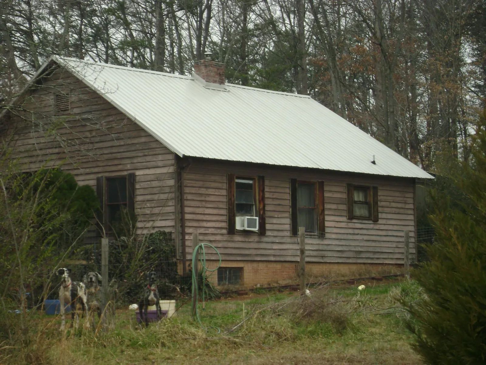 White metal roof on an old wood sided farmhouse, from a Asphalt Shingle Roof Repair job in Lehighton